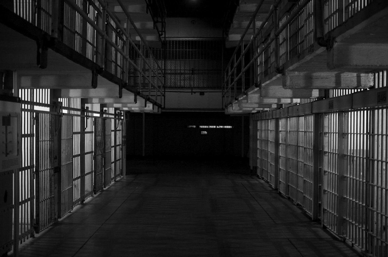 empty prison cell with iron bars representing prayer for incarcerated loved ones