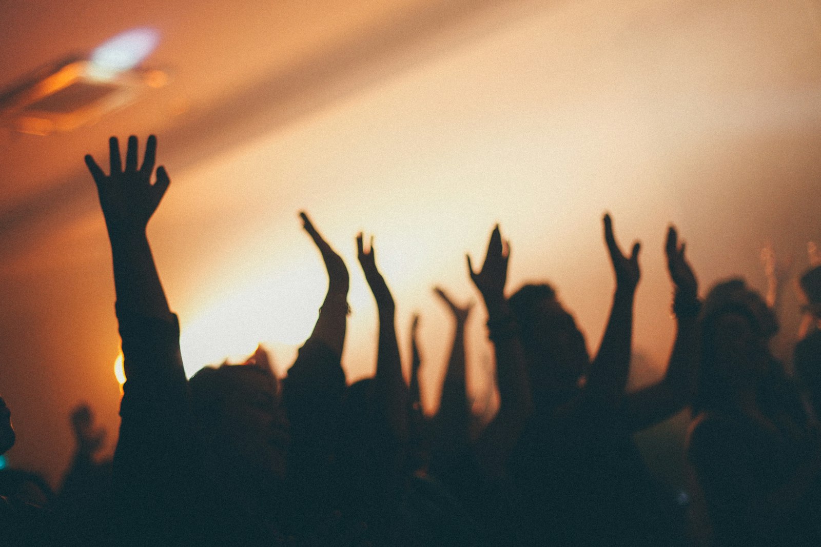 People raising their hands in worship asking God for grace