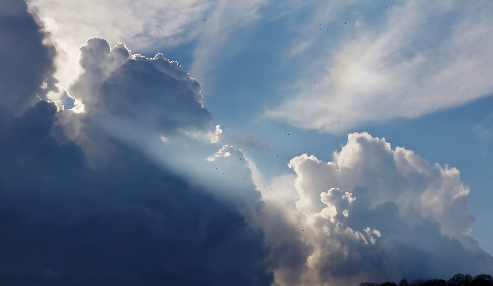Sun rays breaking through heavy storm clouds after a bad report