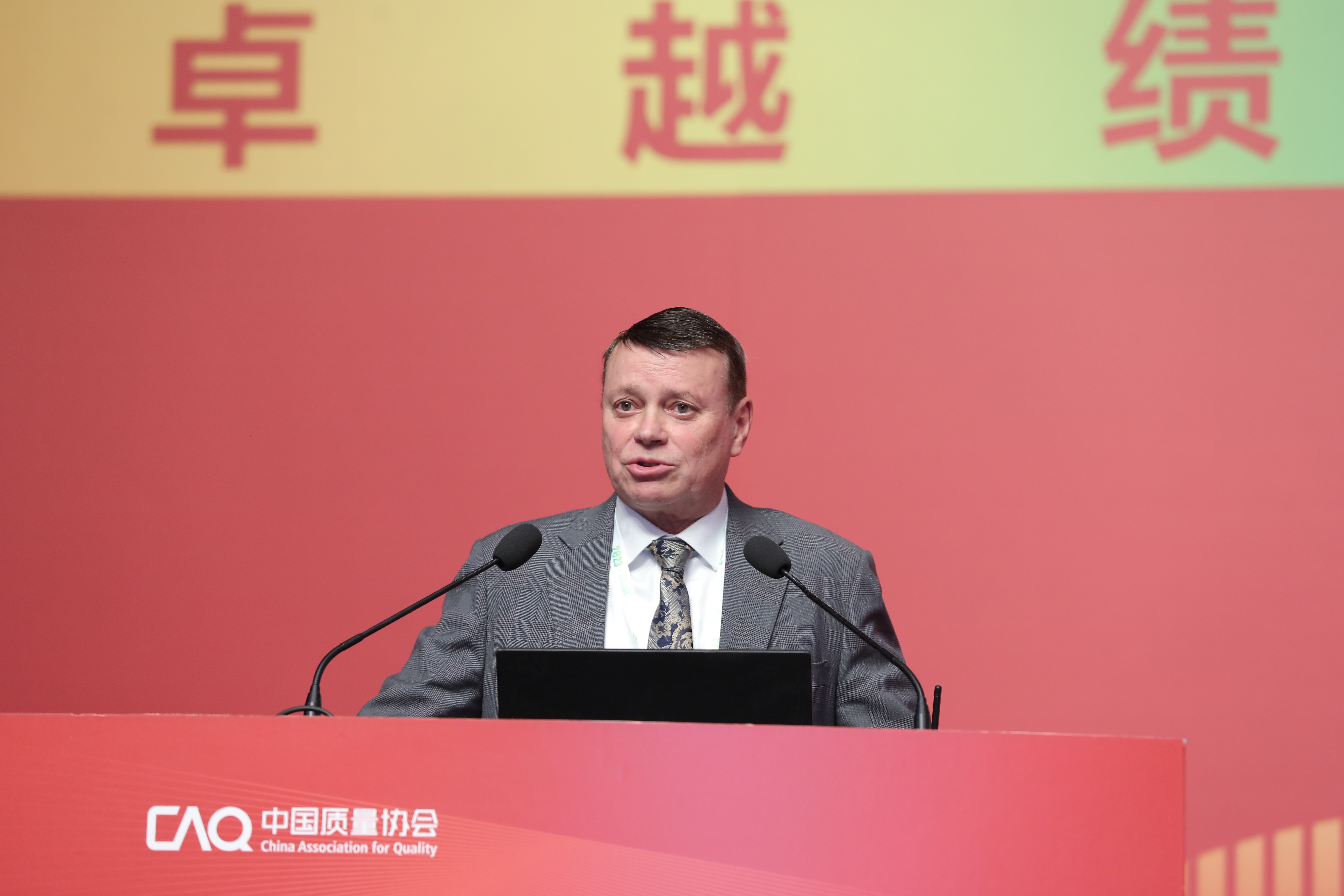 Close up of a presenter standing behind a lectern