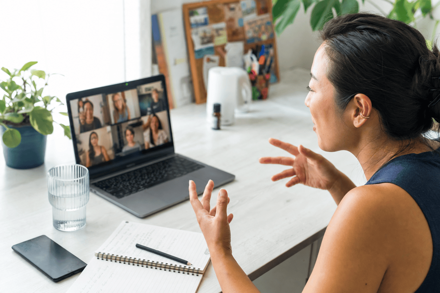 Health coach on a video call with a grid of multiple participants during a live group coaching session