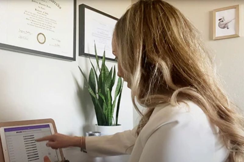 fertility specialist as a desk on a premom virtual consultation call helping an expectant mother