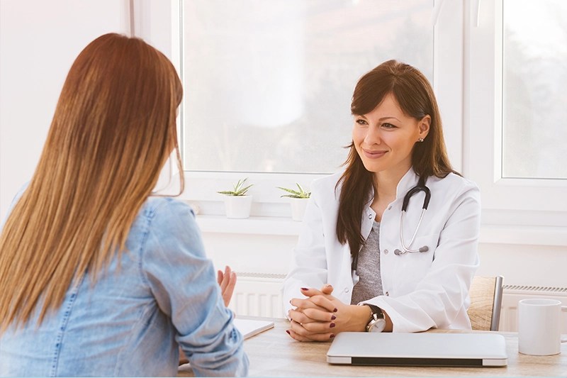 doctor with female patient with pcos struggling with fertility symptoms