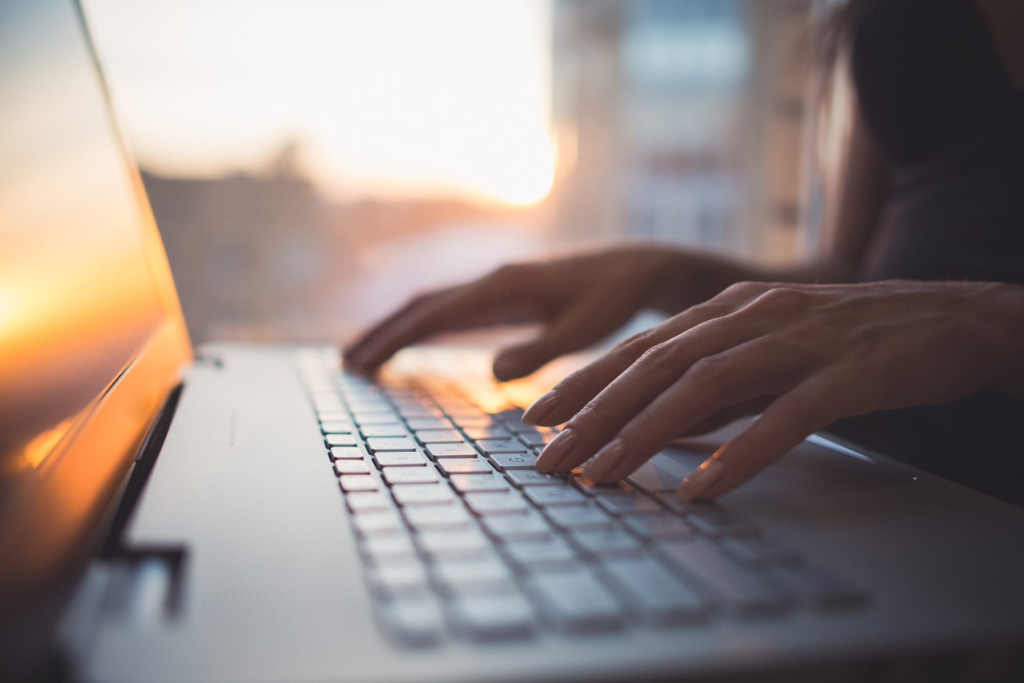 Woman switching from Weebly to WordPress on a laptop