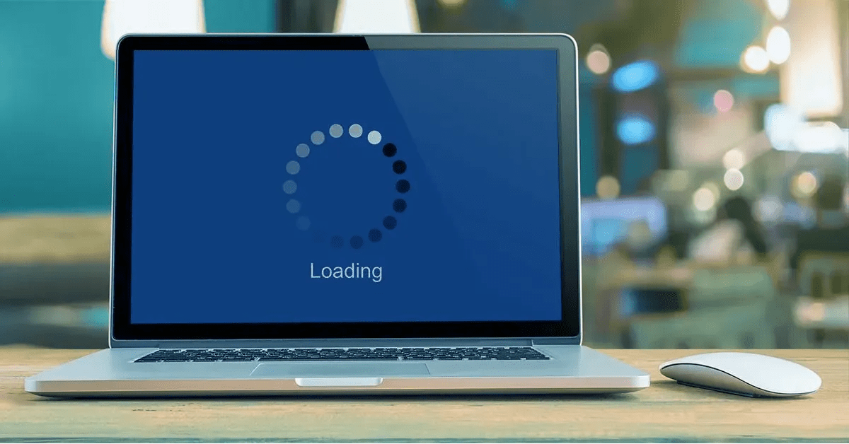 laptop screen with a loading symbol, indicating a slow website