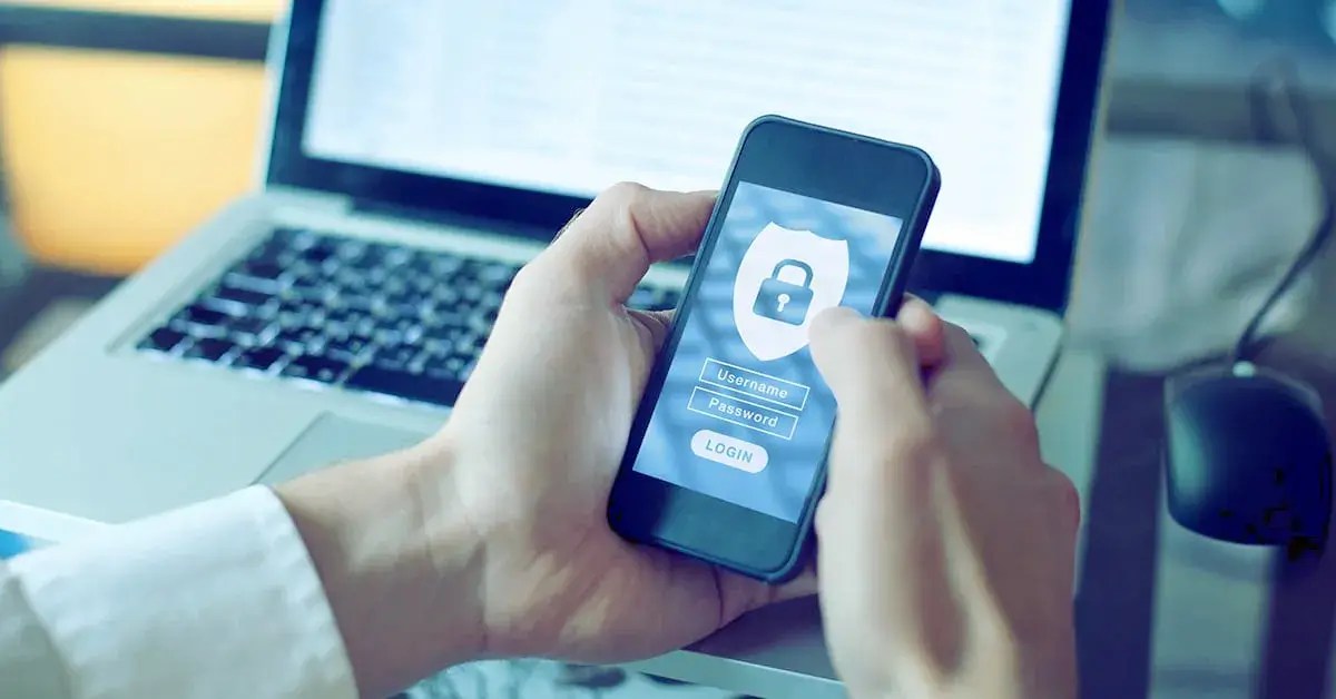 a person holding a cell phone with a website security login on the screen