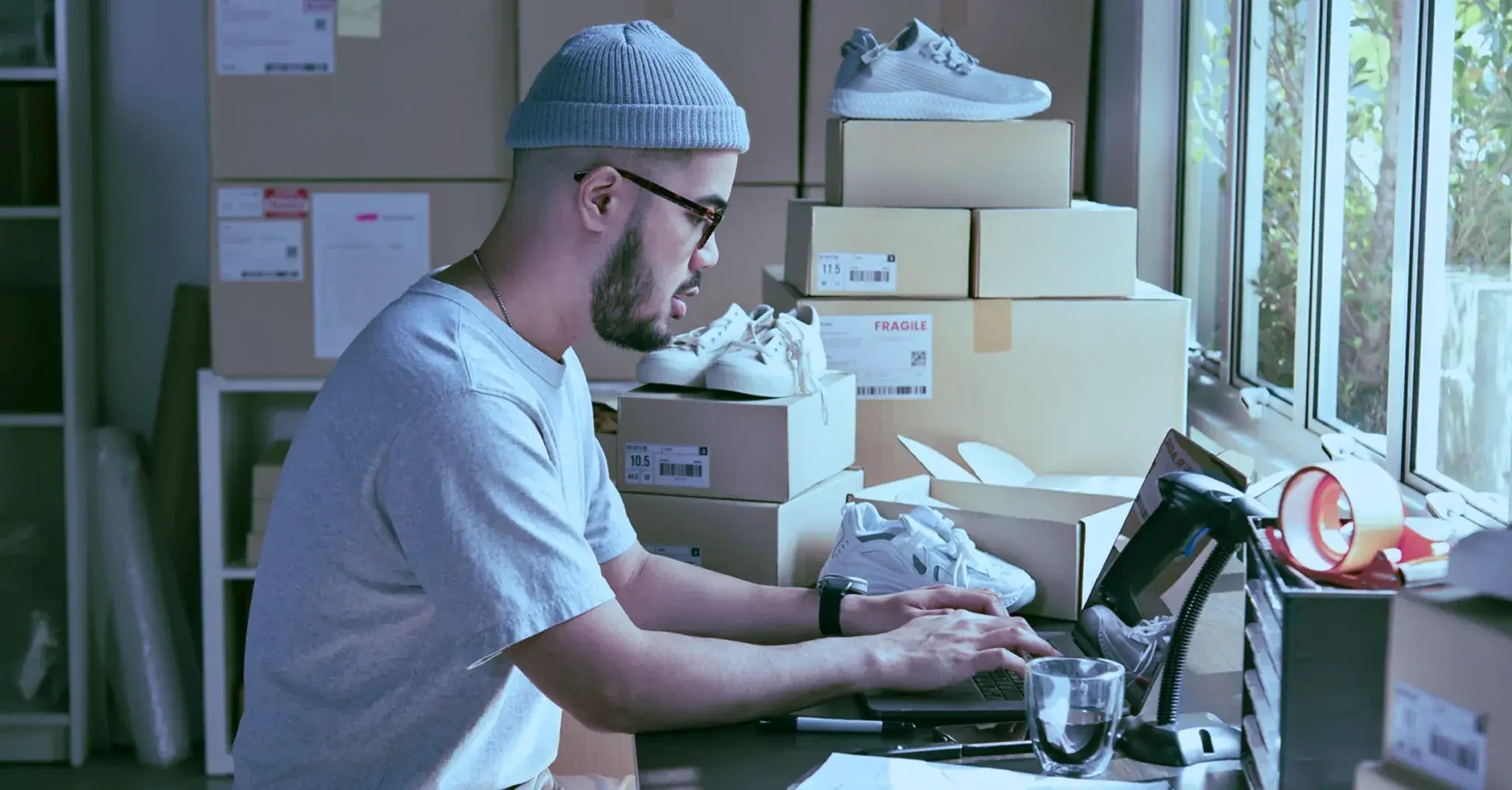 A man working on his WooCommerce website with a PIM tool