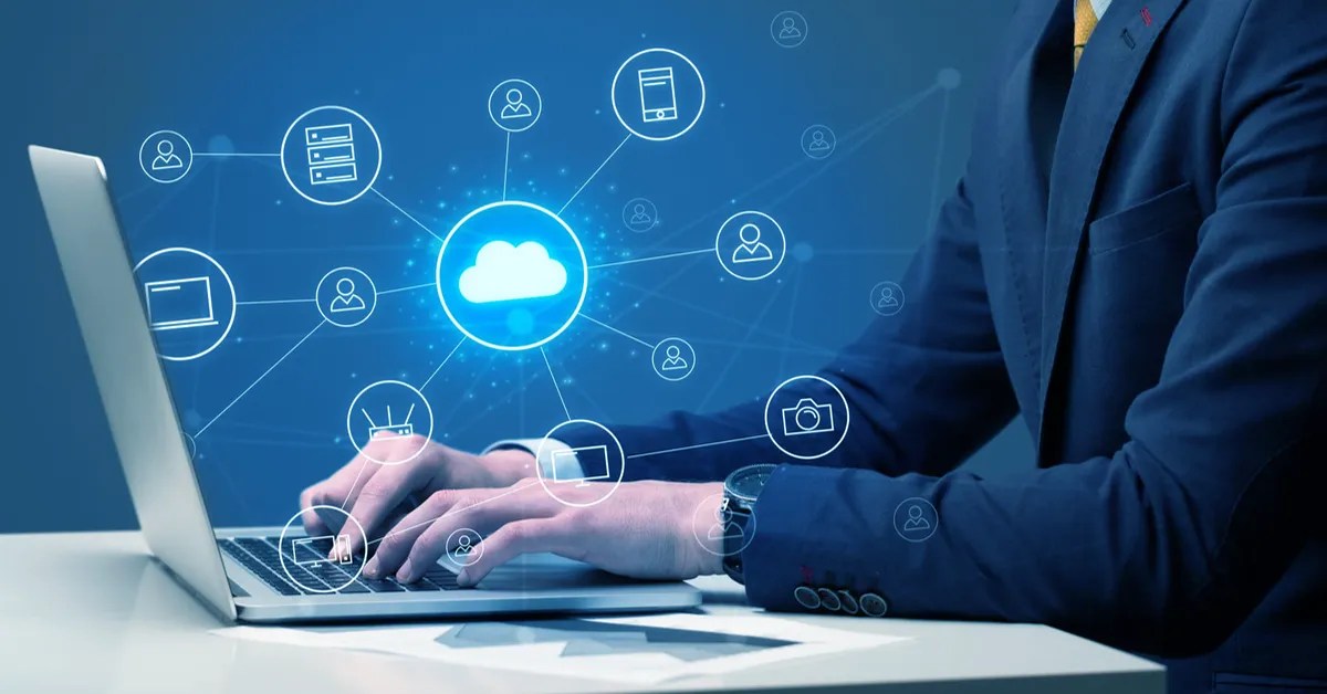 enterprise business person in a suit working on a laptop, and various web related icons