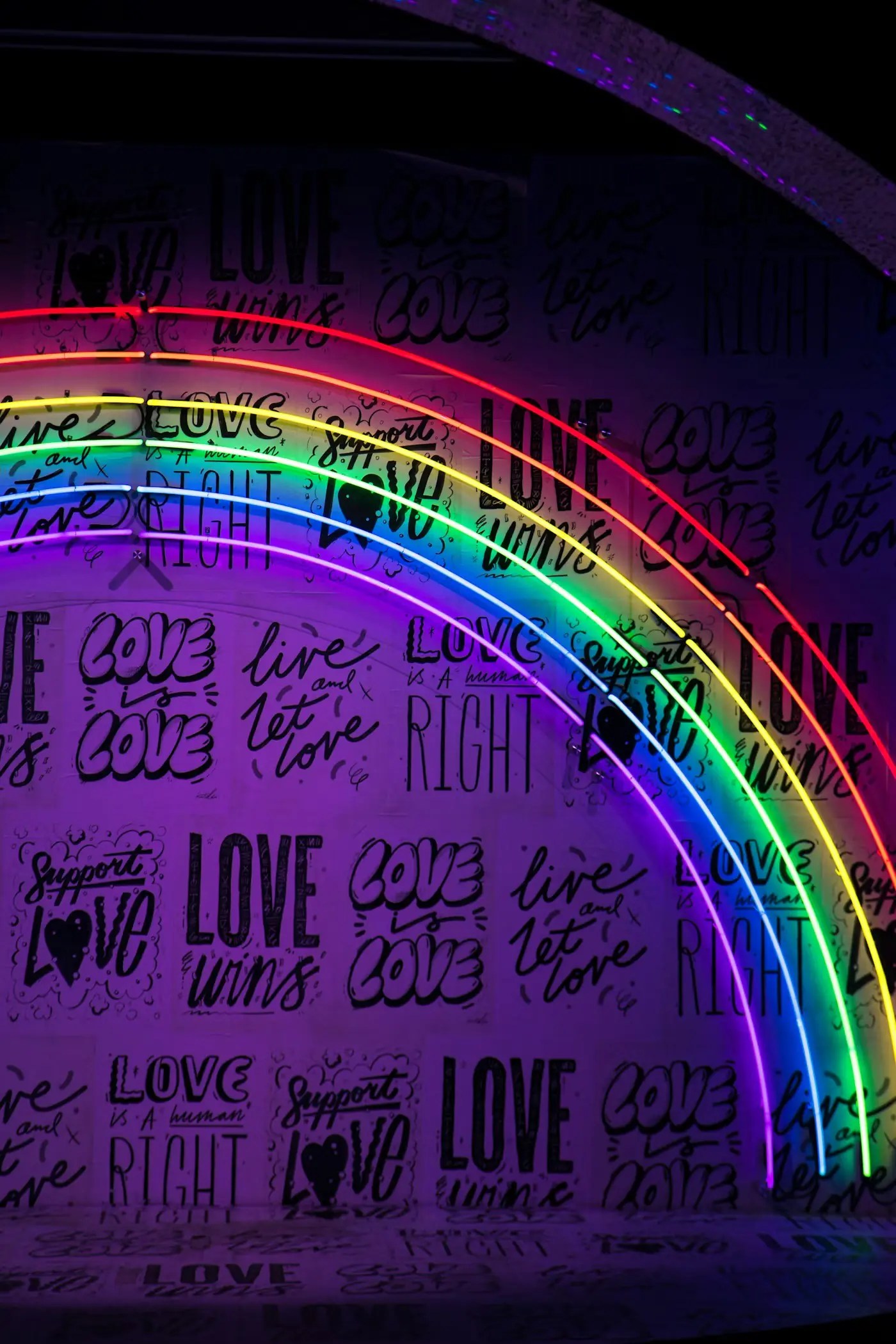 image of a rainbow on a purple wall with pride inspirational quotes