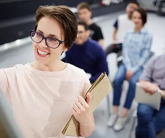 smiling presenter leading a small business marketing workshop