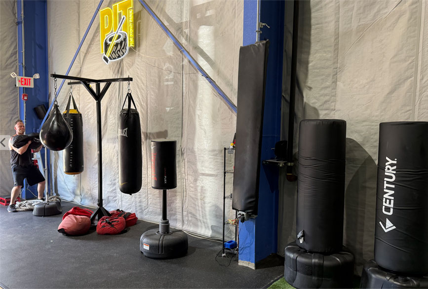 PIT member working heavy bag combinations during boxing training class at King of Prussia gym