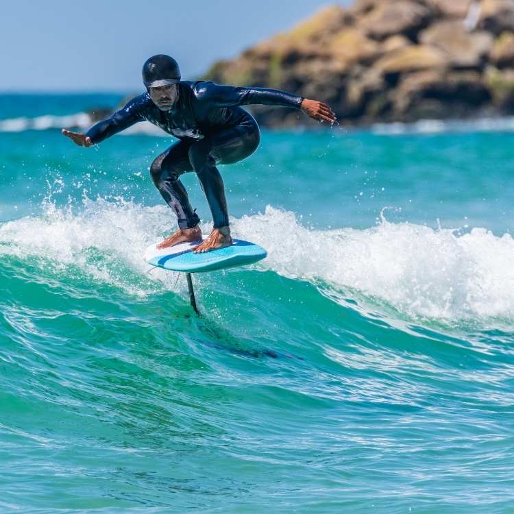 Riding foil board on waves