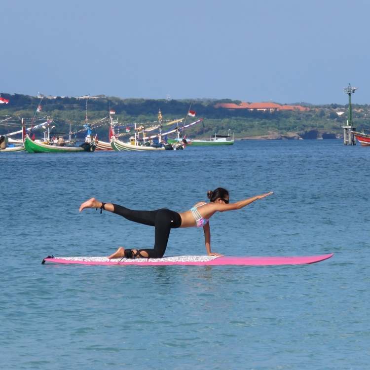 Yoga pose on a board in Bali