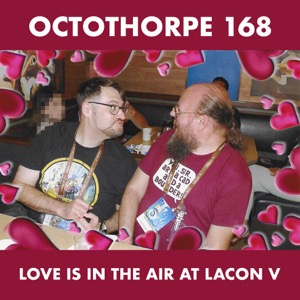 A photograph of John and Duncan MacGregor taken at an IHOP near the Hilton Anaheim. They are turned to look at each other in a booth. Their facial expressions are difficult to read, but hearts overlay the picture and so we surmise they are in love. Faces of bystanders are pixellated for privacy purposes. Words above the photo read “Octothorpe 168” and below read “Love is in the air at LAcon V”.
