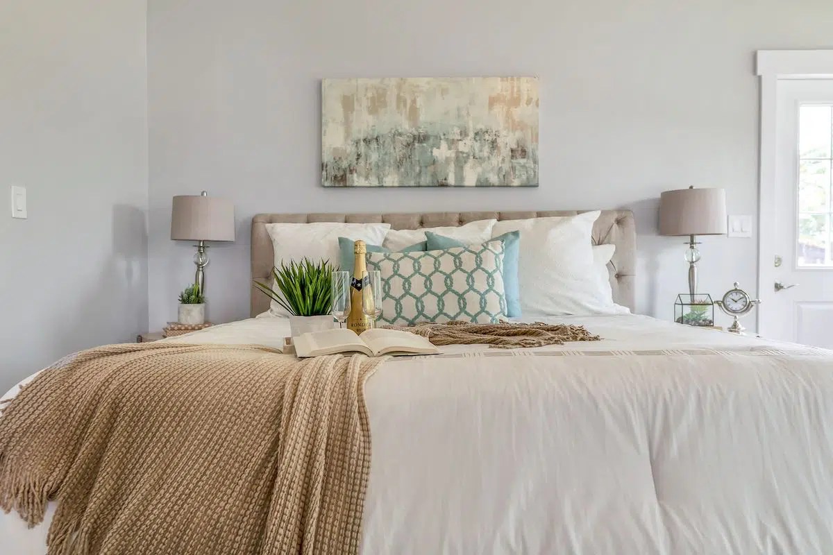 bedroom with white walls white bedding and beige accents. Edmonton