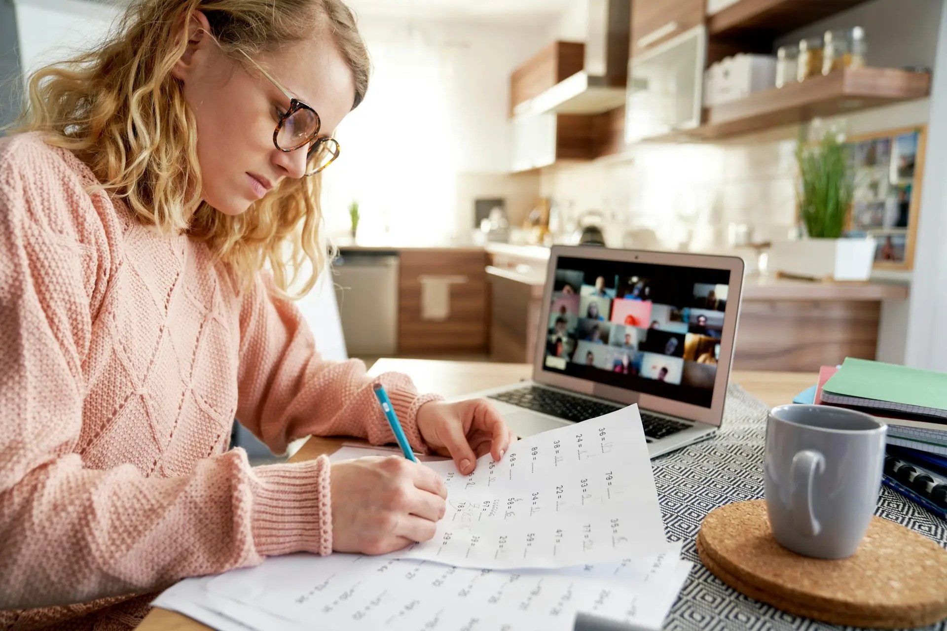 Female teacher evaluates math tasks while homeschooling