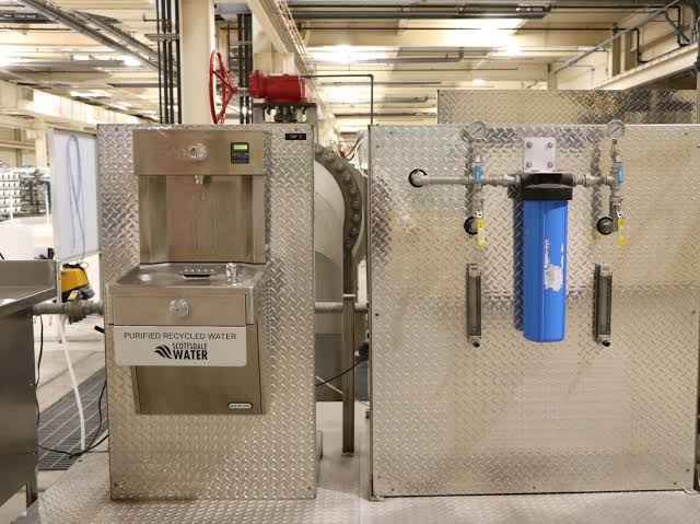 Stainless steel advanced water purification equipment installed inside a treatment facility.