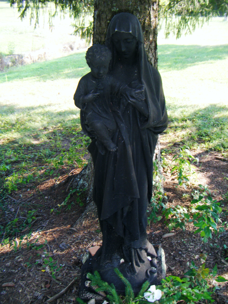 Mary, stepping upon Serpent while holding child Jesus.