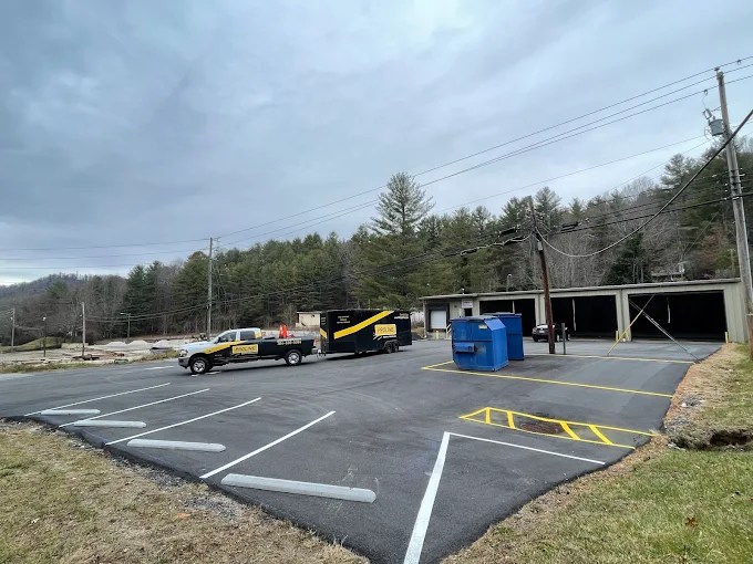 Empty parking lot with utility vehicles.