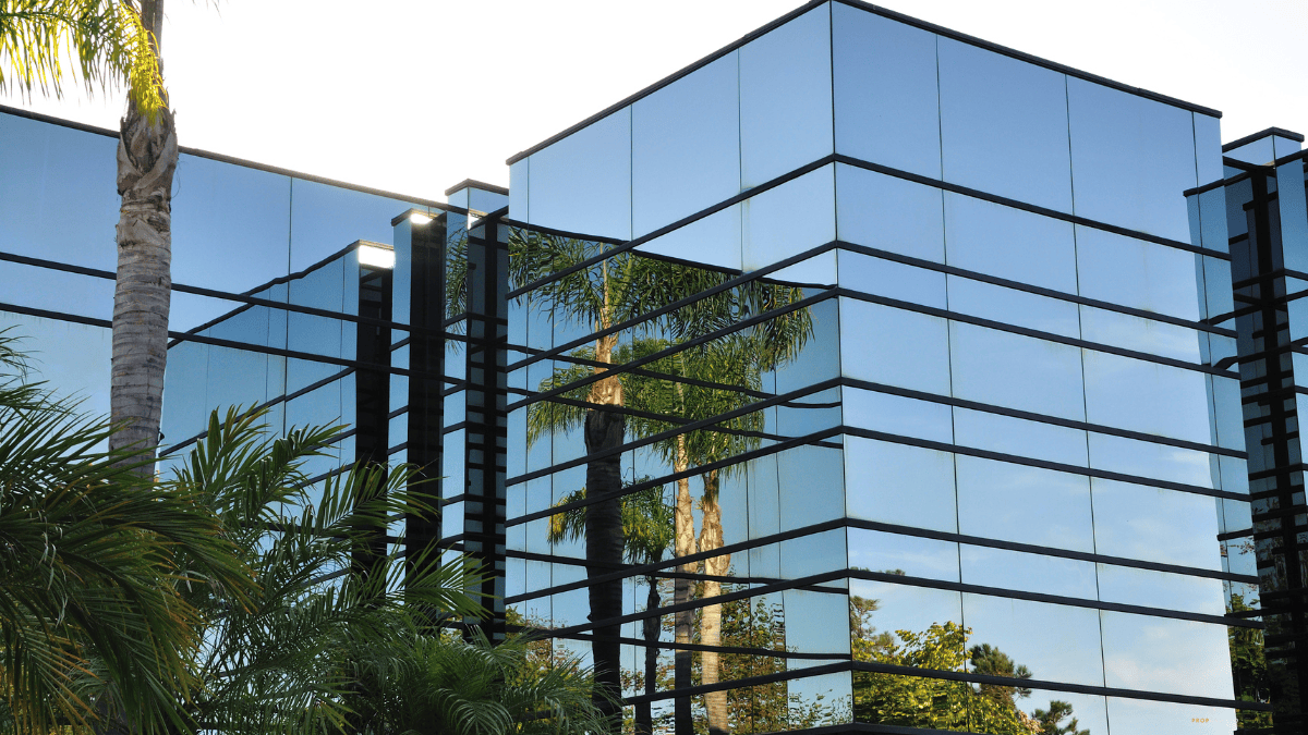 Modern commercial real estate office building with reflective glass windows