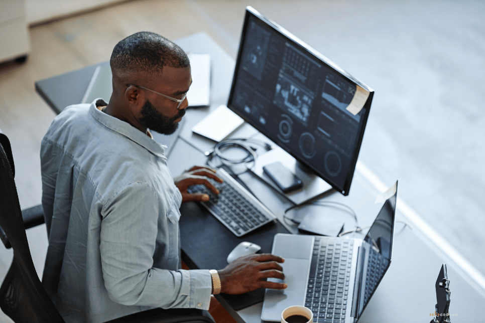 Real estate professional working with CRM software across desktop and laptop screens