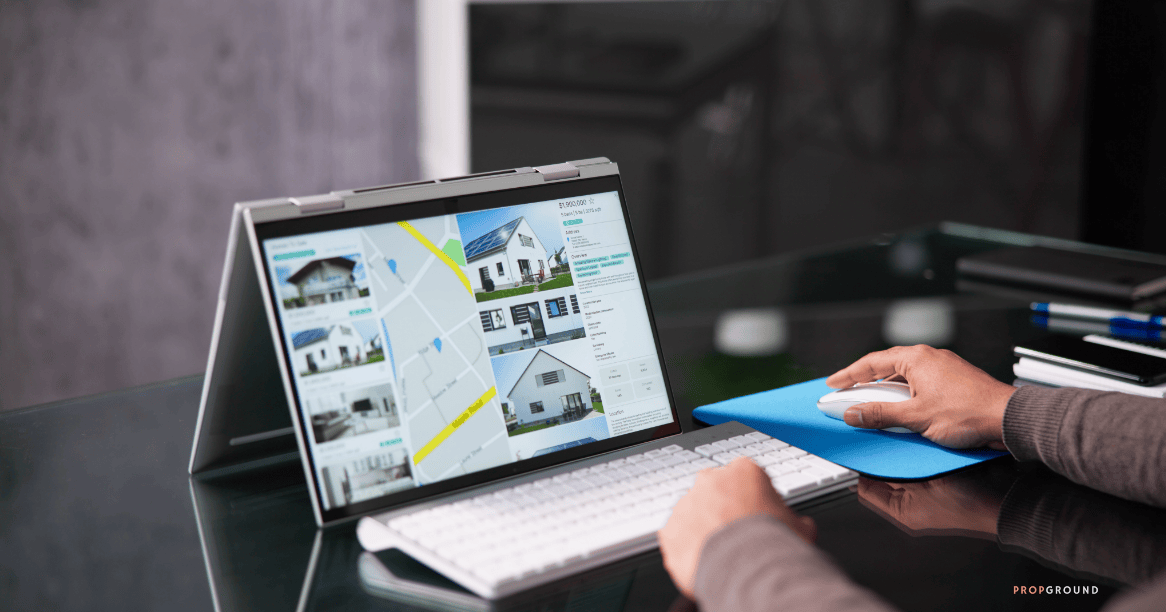 Real estate professional reviewing property listings and CRM data on a computer