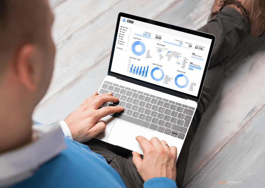Real estate agent using a CRM dashboard to track leads, sales activity and performance