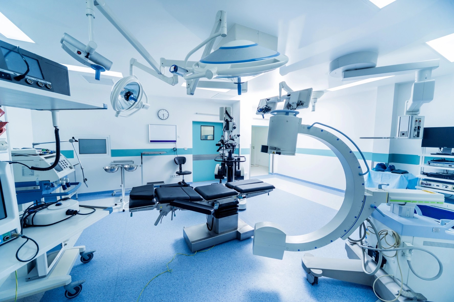 Blue-tinted medical room with multiple medical equipment