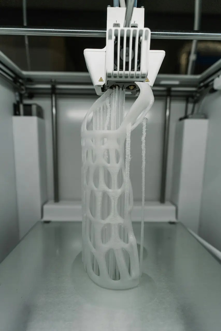 A high-precision 3D printer creating a custom part layer by layer, demonstrating advanced additive manufacturing technology.