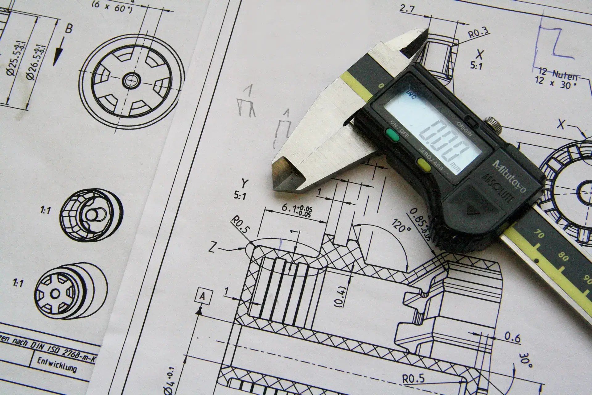 A detailed technical drawing with precise measurements, accompanied by a pair of callipers, symbolizing accuracy in 3D design and manufacturing.