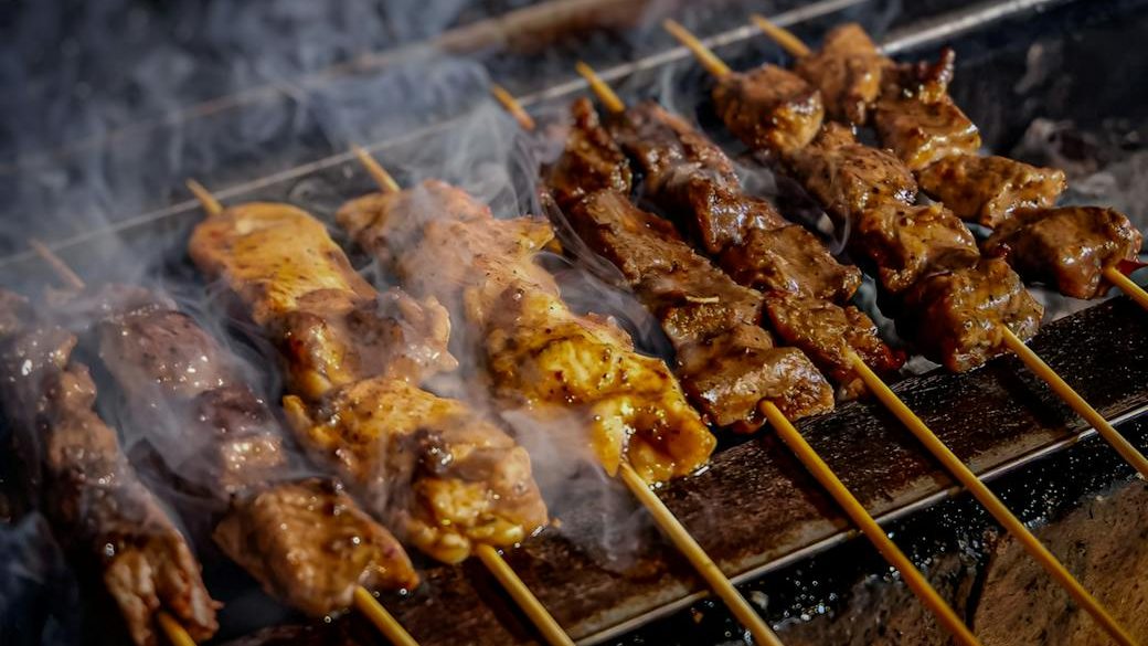 close up photo of chicken satay street food