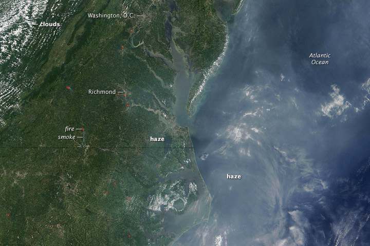 The Moderate Resolution Imaging Spectroradiometer (MODIS) on NASA's Terra satellite captured this image of haze in the eastern United States on July 26, 2005. Easier to see over the ocean, haze hangs over the Mid-Atlantic region. Fires are marked with red dots. (Photo courtesy of NASA)