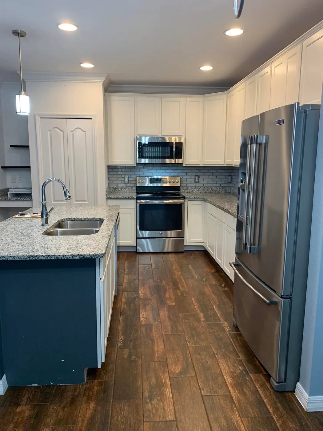 Spotless kitchen with granite counters and stainless appliances