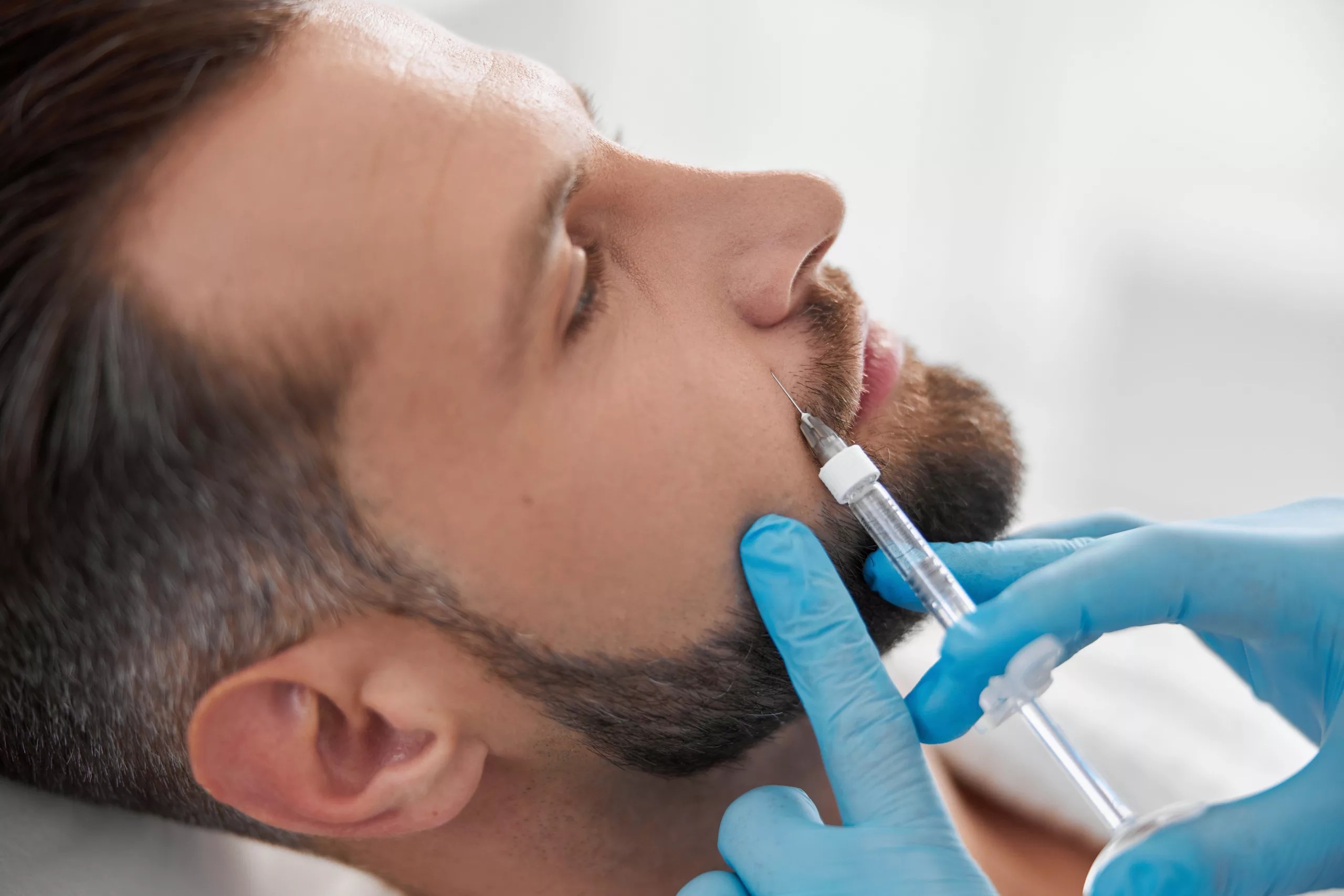 man getting injectable near nose