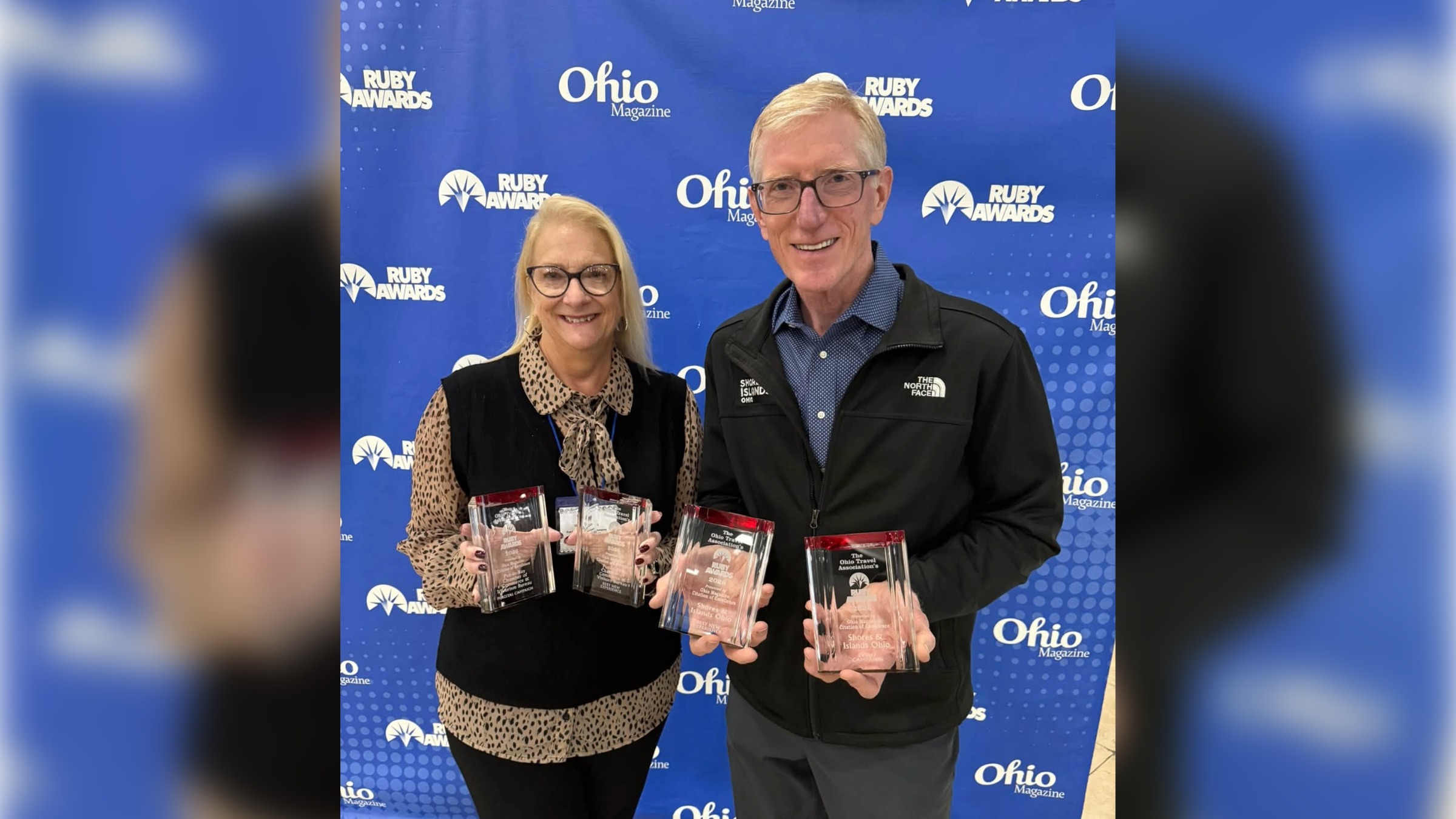 Wendy Chambers, director of the Put-in-Bay Chamber, and Larry Fletcher, director of strategic alignment for Shores & Islands Ohio, holding their 2026 RUBY Awards Citations of Excellence.