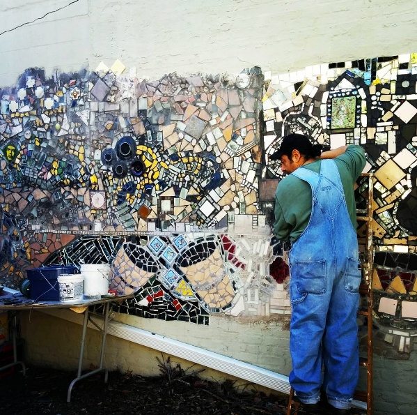 Artist Carlos Pinto, working on the Q Gardens mural