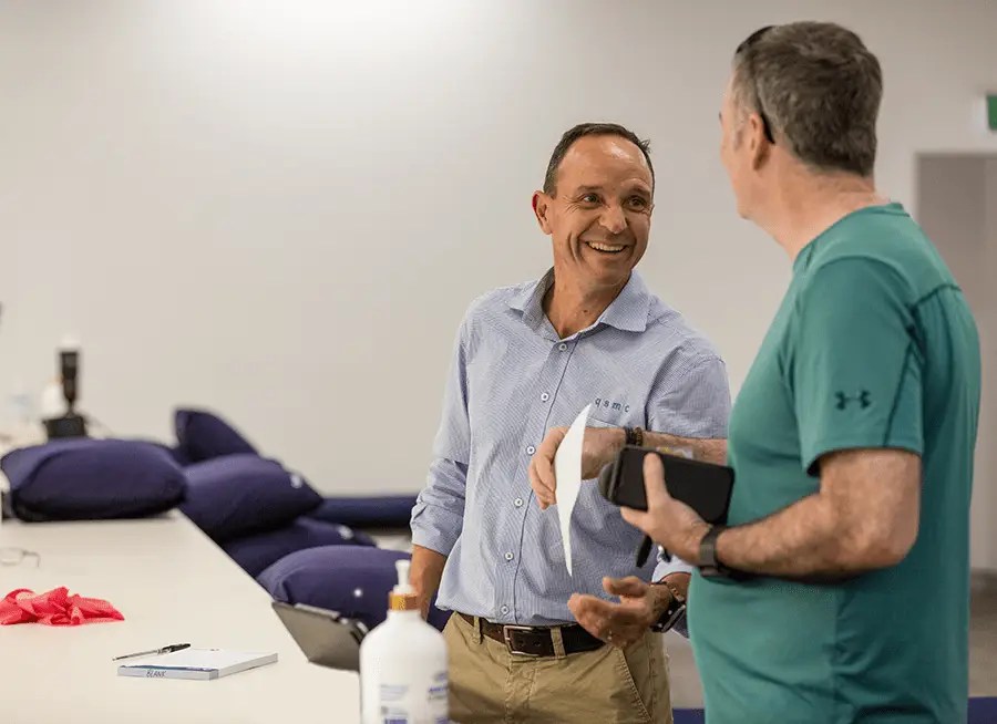 Senior Physiotherapist Rob Godbolt talking to a QSMC client after a Physio appointment