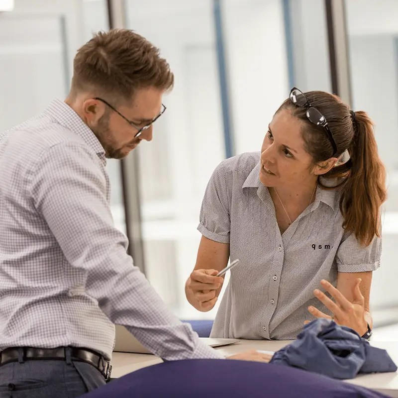 Physiotherapist Marguerite King speaking to another clinician at the QSMC clinic in Bowen Hills