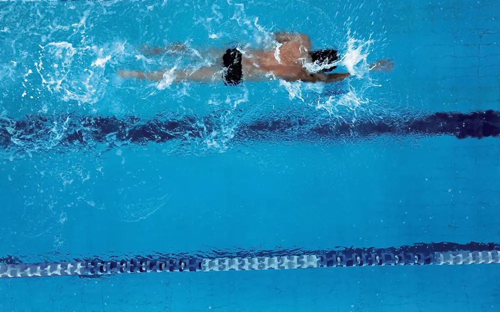 Image of a swimmer doing freestyle through a pool