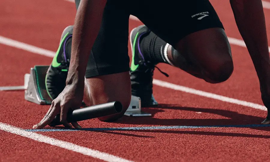 Track athlete in the starting blocks about to start a relay race