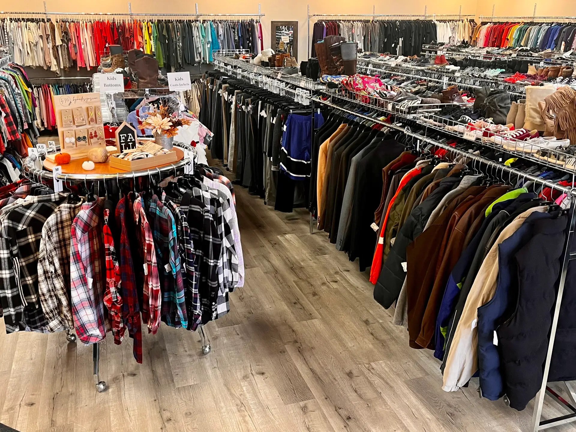 Clothing racks and a display table inside Quality Shoppe