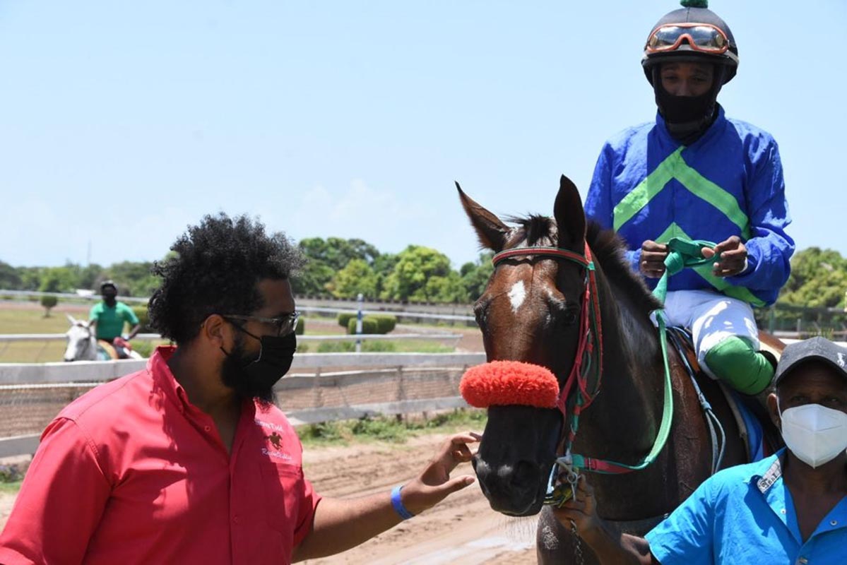 Trainer Steven Todd (left) leading in Triple Seven with Jerome Innis in the saddle.