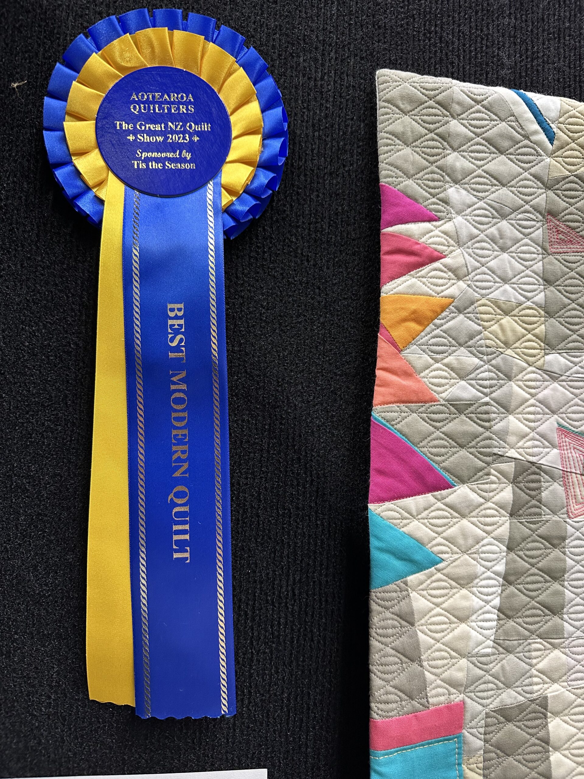 blue ribbon on a modern quilt
