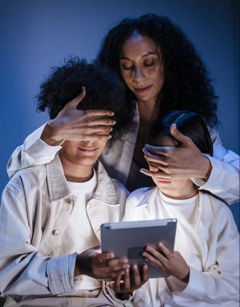 Photo by Ron Lach on <a href="https://www.pexels.com/photo/mother-covering-eyes-of-her-children-with-hands-against-internet-content-on-digital-pad-9786312/" rel="nofollow">Pexels.com</a>