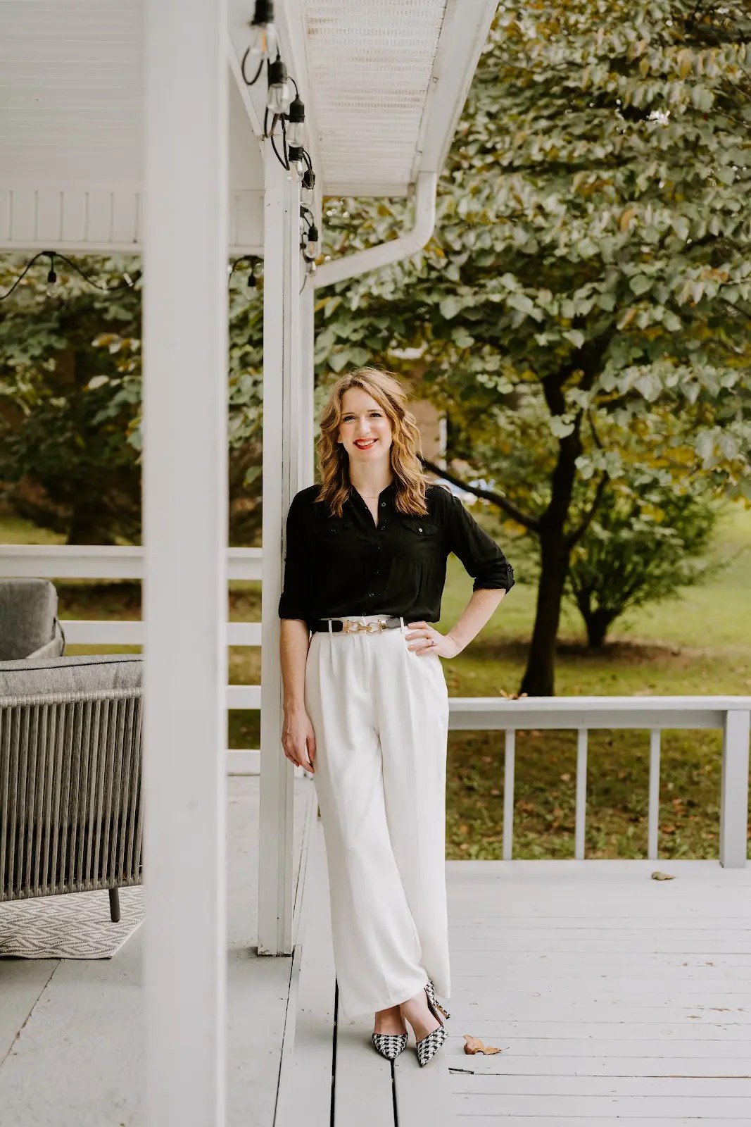 Rachel Ferrell standing on a spacious covered porch