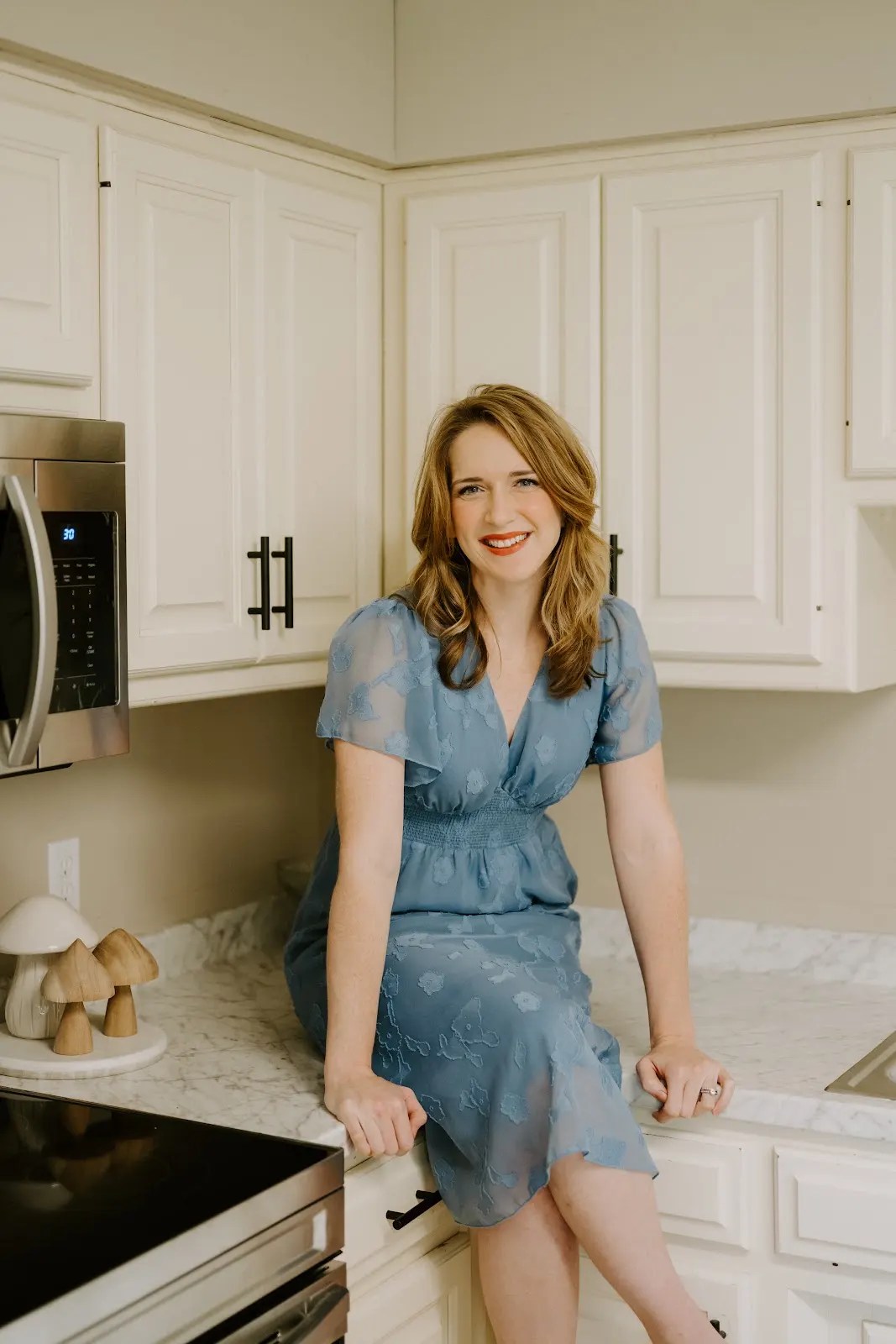 Rachel Ferrell seated on a kitchen counter