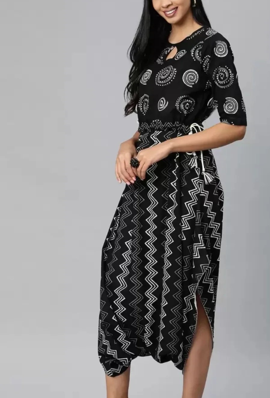 Black printed Dhoti Style jumpsuit, has a round neck, short sleeves