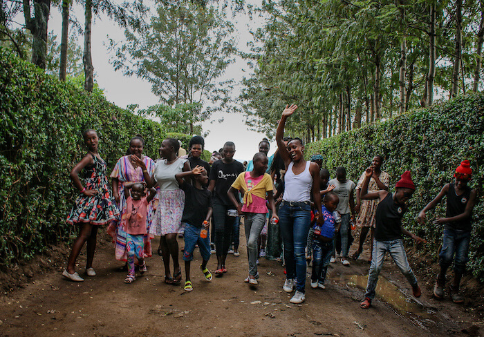 Staff and children walk down driveway at Doyle Farm in Kenya
