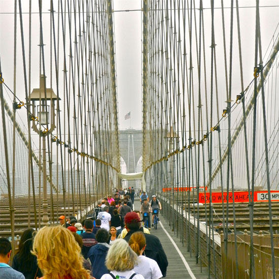Crowds ebb and flow across.