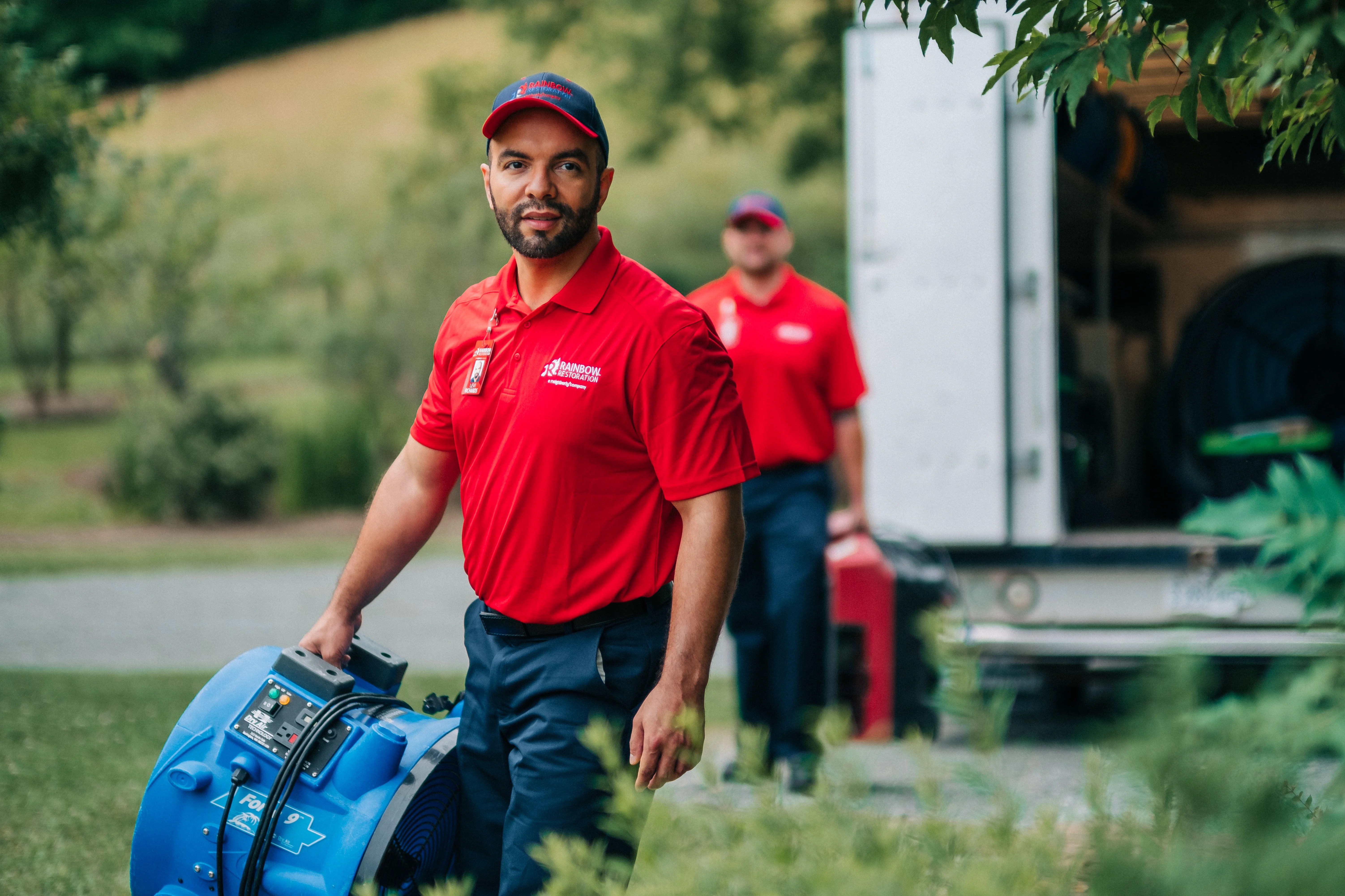 water damage repair specialist bringing equipment into home